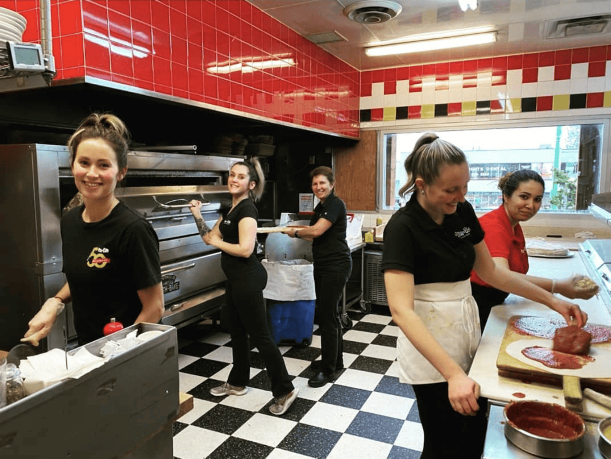 About Me-n-Ed's Pizza: Cris and the team working in the kitchen.